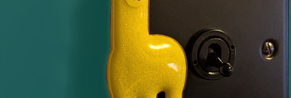A Yellow Llama magnetised to a light switch