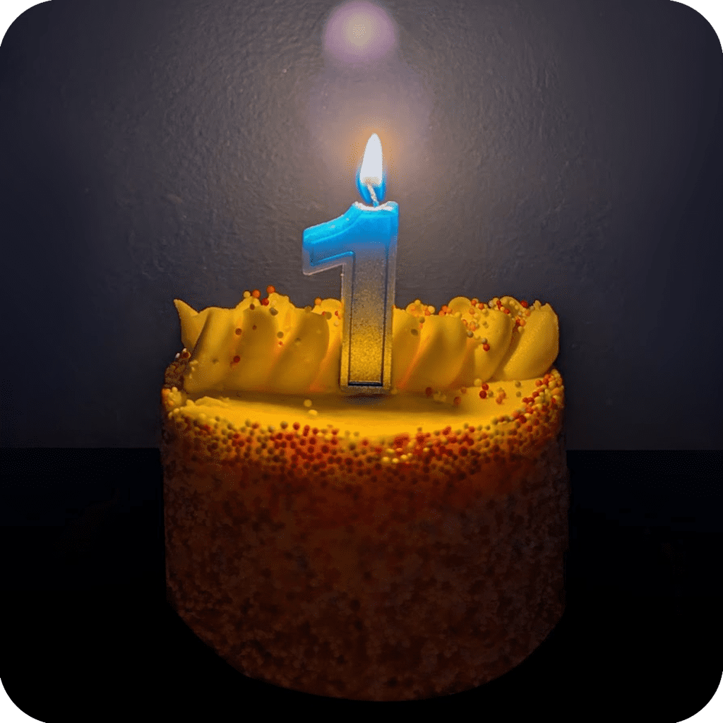 a 1st birthday cake with the candle lit